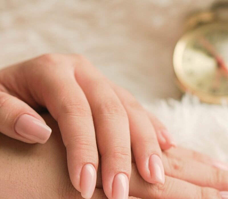person wearing gold and silver round analog watch