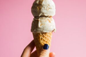person holding ice cream on cone