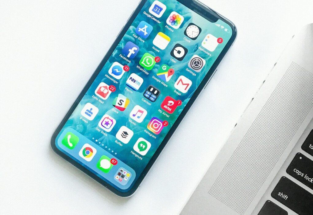 white smartphone near laptop